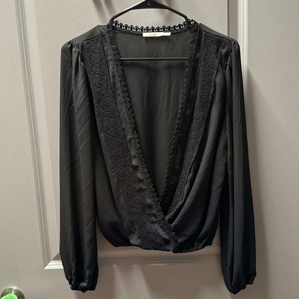 Mi Ami black top with lace hem and front detail. Long-sleeve.